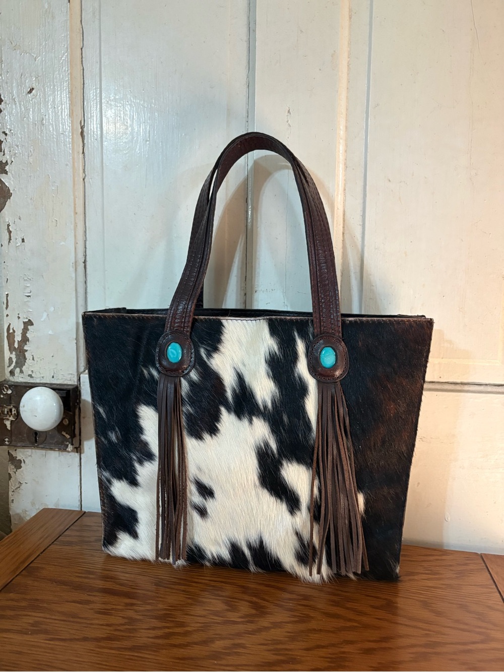 Patricia Nash Cowhide Fringe Tote Bag with Turquoise Accents.